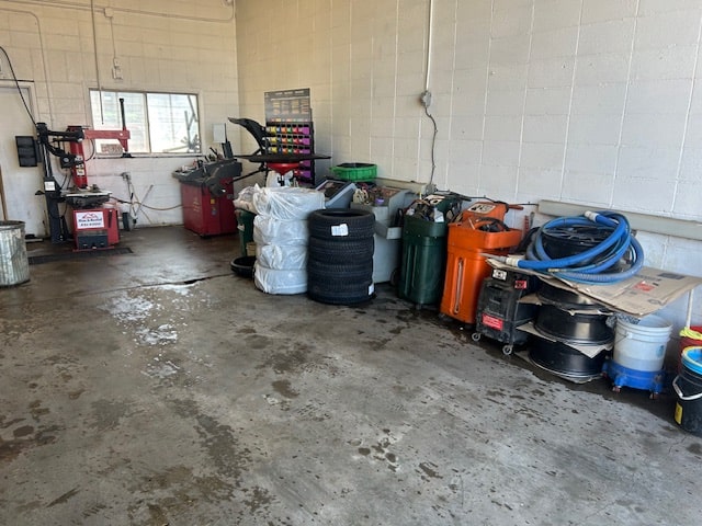 Auto repair tools and equipment stored in a garage setting.
