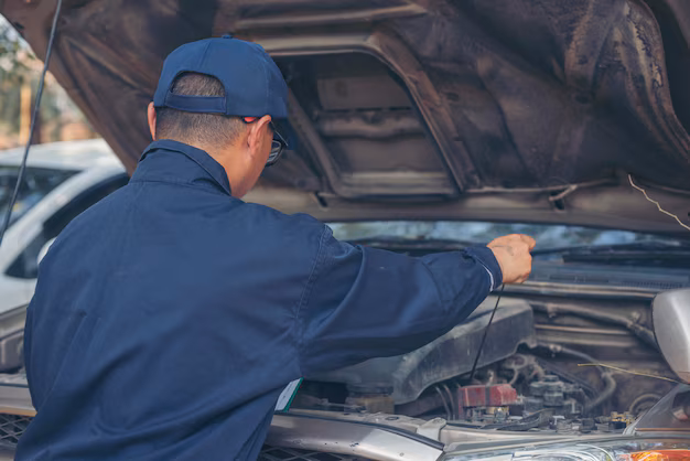 a mechanic inspecting engine oil readings
