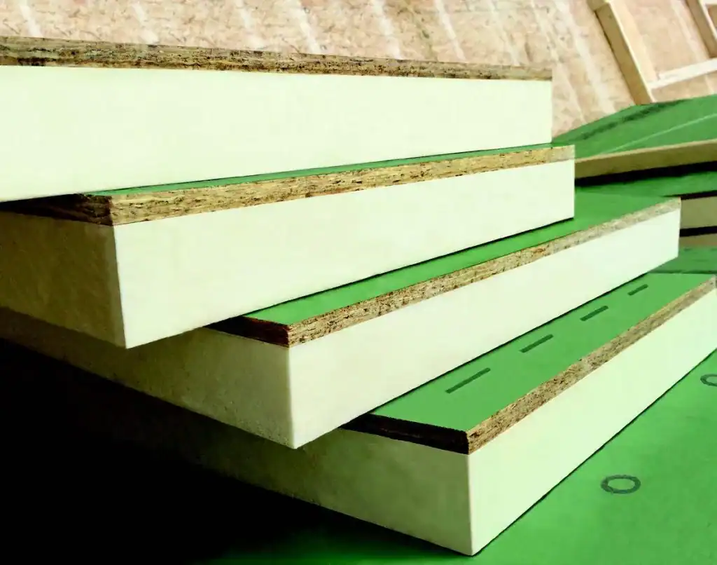 Close-up of green and white rigid insulation foam boards stacked for construction use.