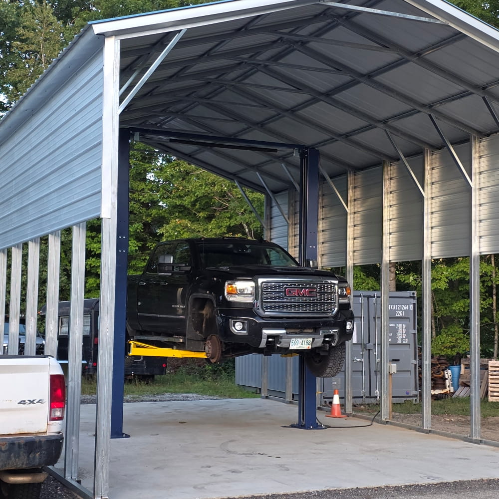 GMC truck lifted at Forrest Howes Auto Repair for maintenance or repair.