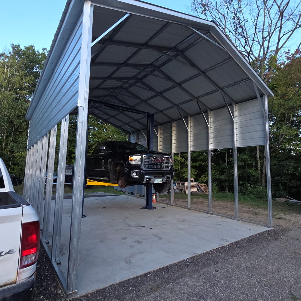 Vehicle lift in outdoor auto repair bay at Forrest Howes Auto Repair.