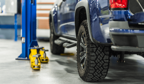 Vehicle lifted on hydraulic lift at Franconia Auto Care for maintenance or repair.