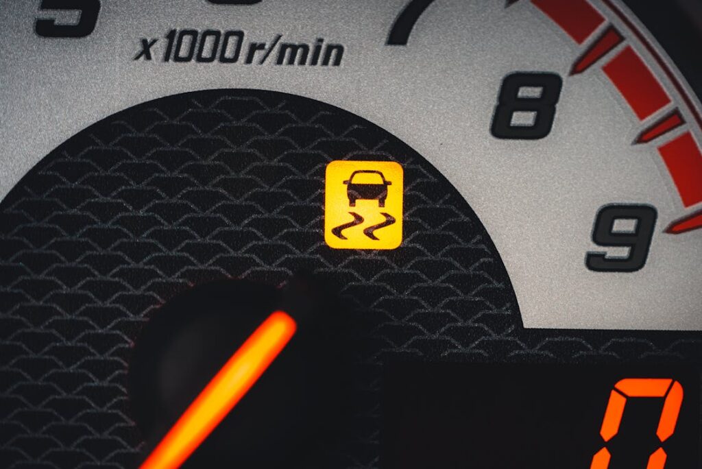 Engine warning light on dashboard signaling urgent vehicle maintenance.