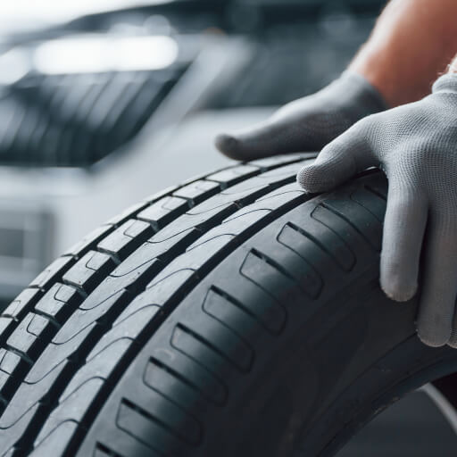 Technician inspecting an electric vehicle tire at Garage-EV in Dartmouth.