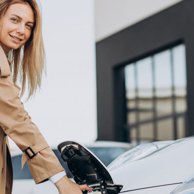Woman charging an electric vehicle at Garage-EV in Dartmouth.