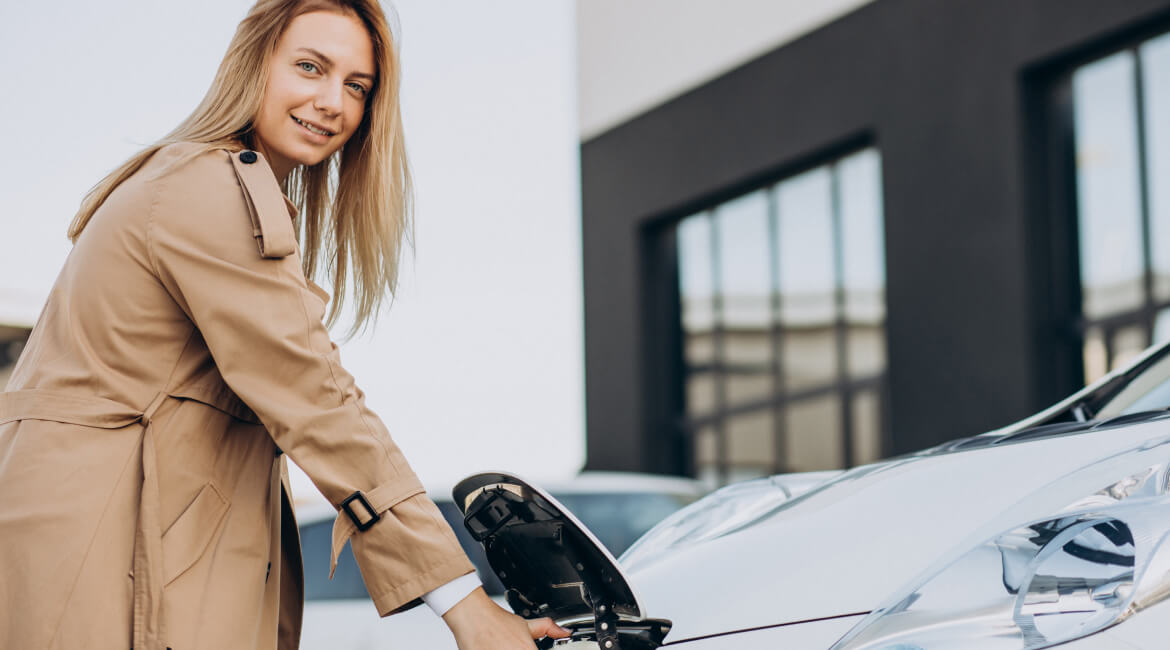 Woman charging an electric vehicle at Garage-EV in Dartmouth.