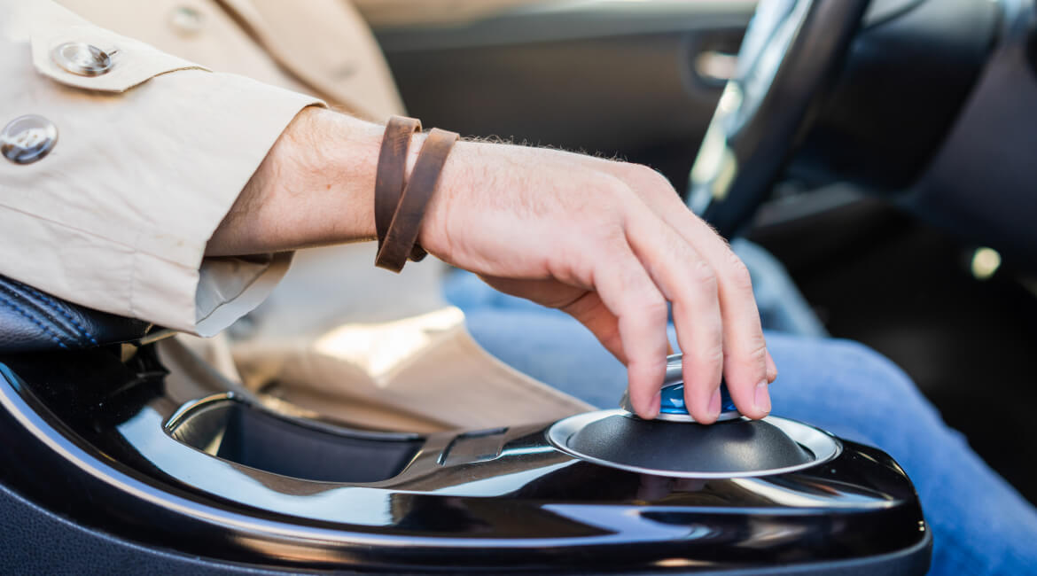 Close-up of hand shifting gear in electric vehicle at Garage-EV.