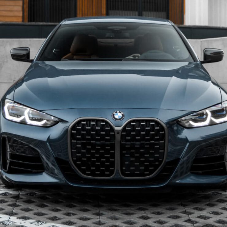 Blue BMW M3 sedan parked at Garage-EV service center in Dartmouth.