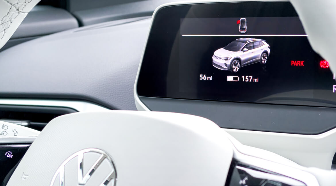 Electric vehicle dashboard showing range and charging status.