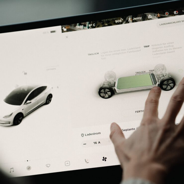 Person designing electric vehicle on tablet at Garage-EV Dartmouth.