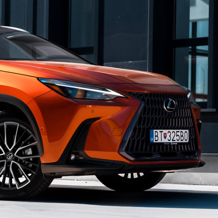 Orange Lexus UX electric vehicle parked outside Garage-EV in Dartmouth.