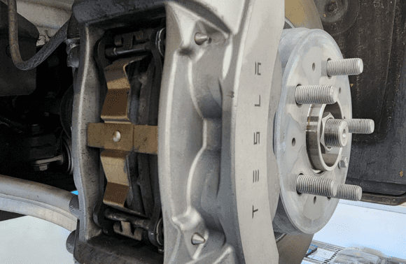 Close-up of electric vehicle brake caliper and rotor at Garage-EV Dartmouth.