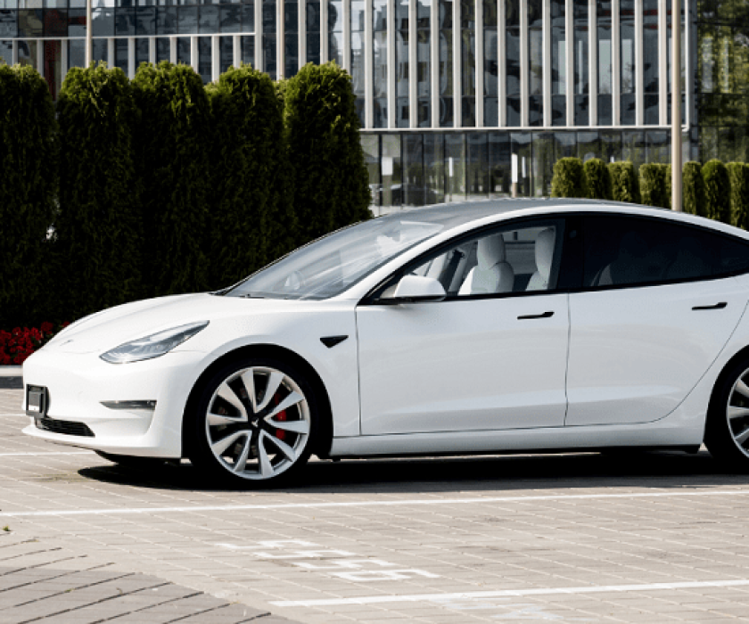 White electric car parked outside Garage-EV service center in Dartmouth.