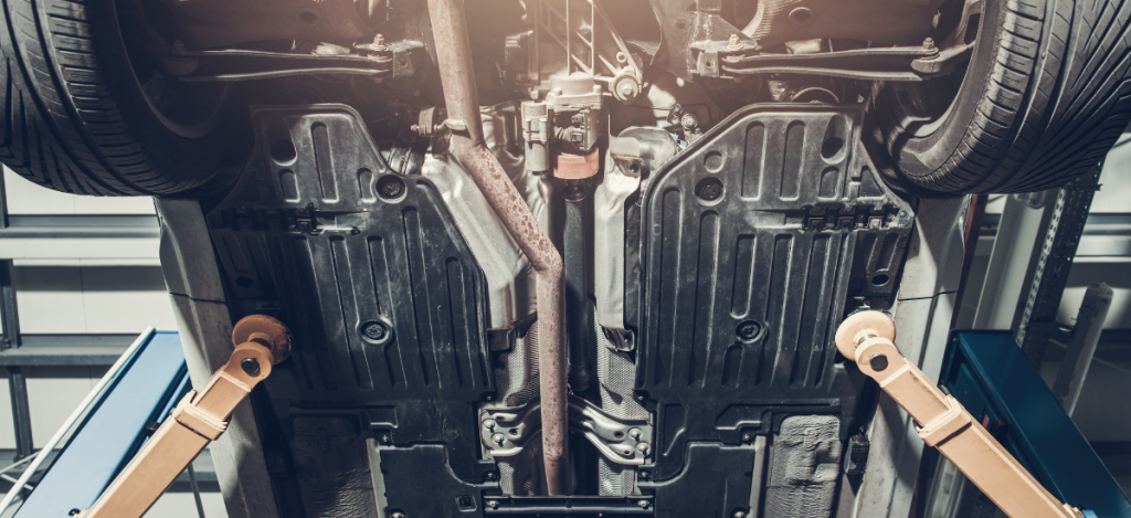 Underside of a vehicle with undercoating applied for rust protection.
