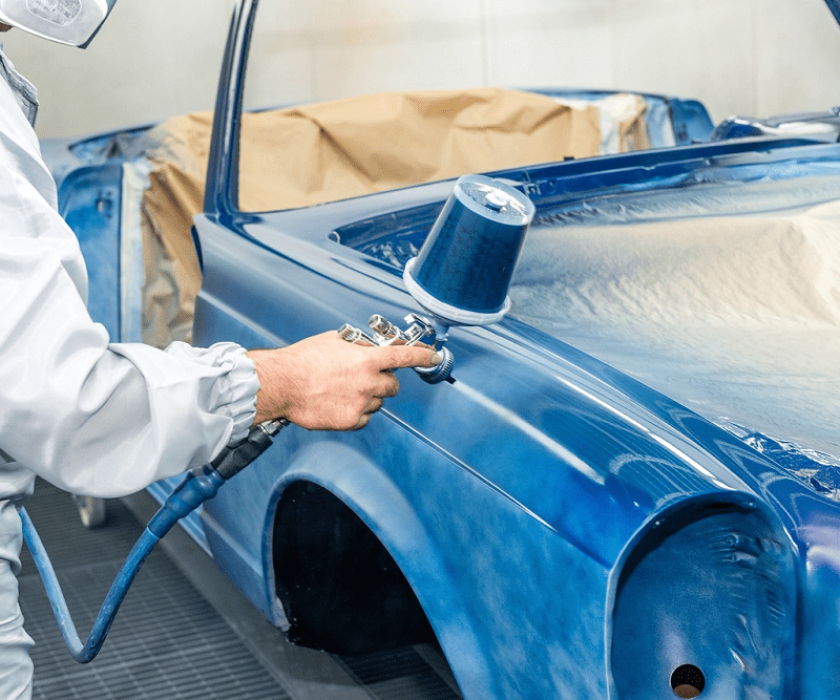 Technician applying protective coating to a classic car at Garage-EV Dartmouth.
