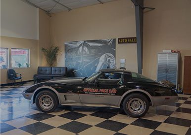 Optical Force Car Service - Classic Black Sports Car in Auto Repair Shop.