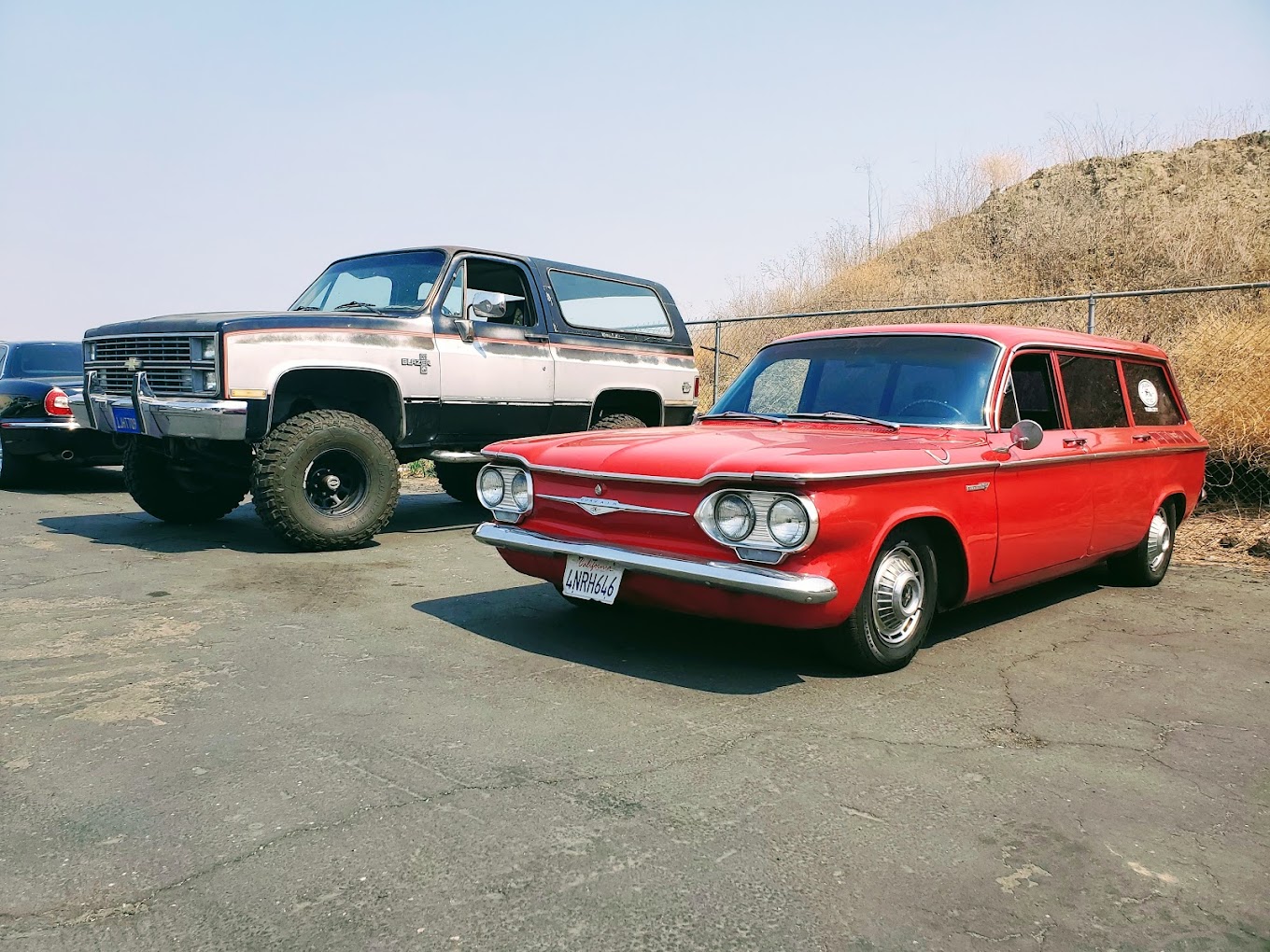 Classic Grumpy's Hot Rod station wagon and rugged SUV displayed outdoors.