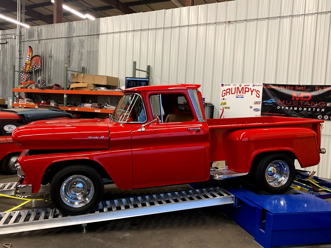Classic red vintage pickup truck at Grumpy's Hot Rod shop.