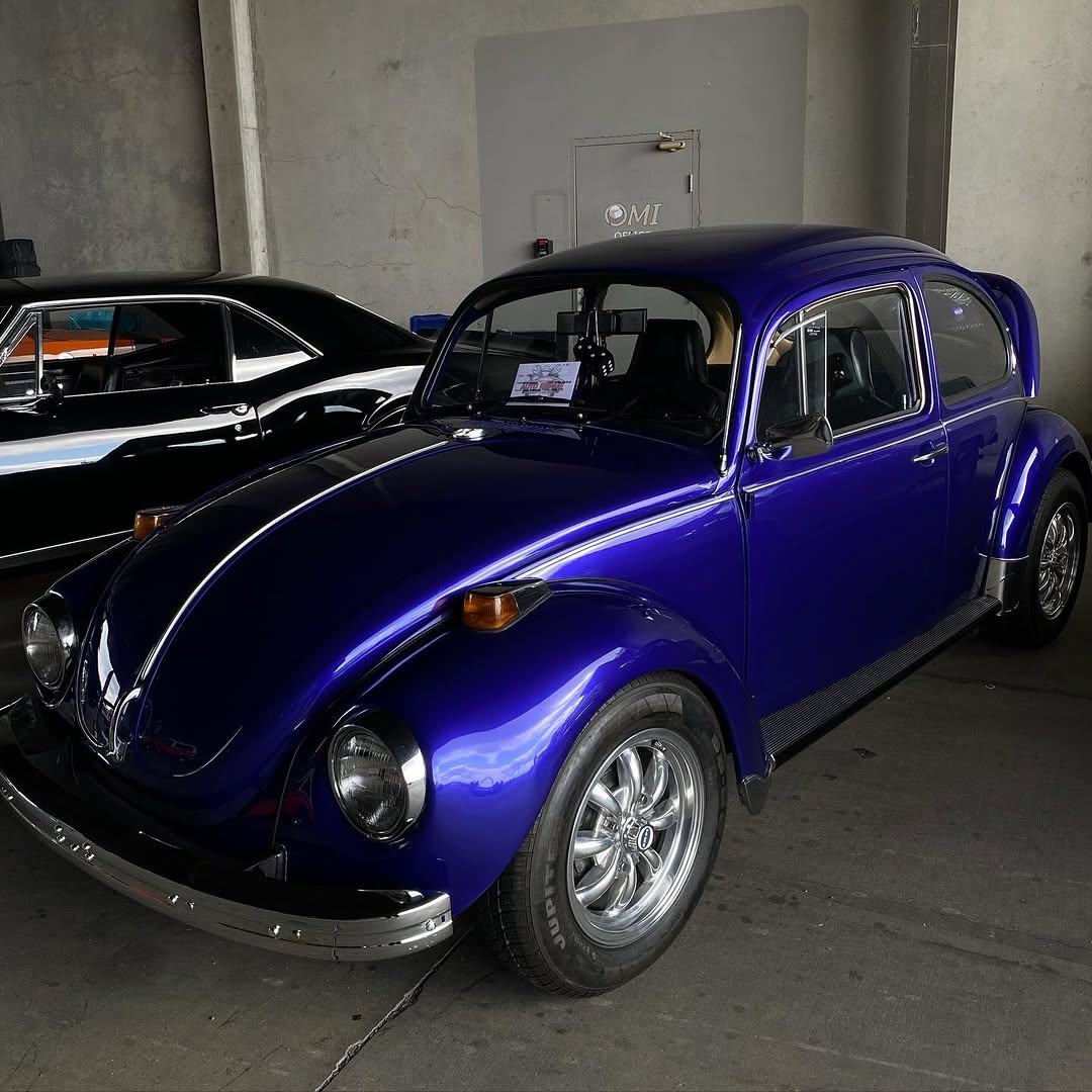 Classic Volkswagen Beetle hot rod with custom modifications and shiny finish.
