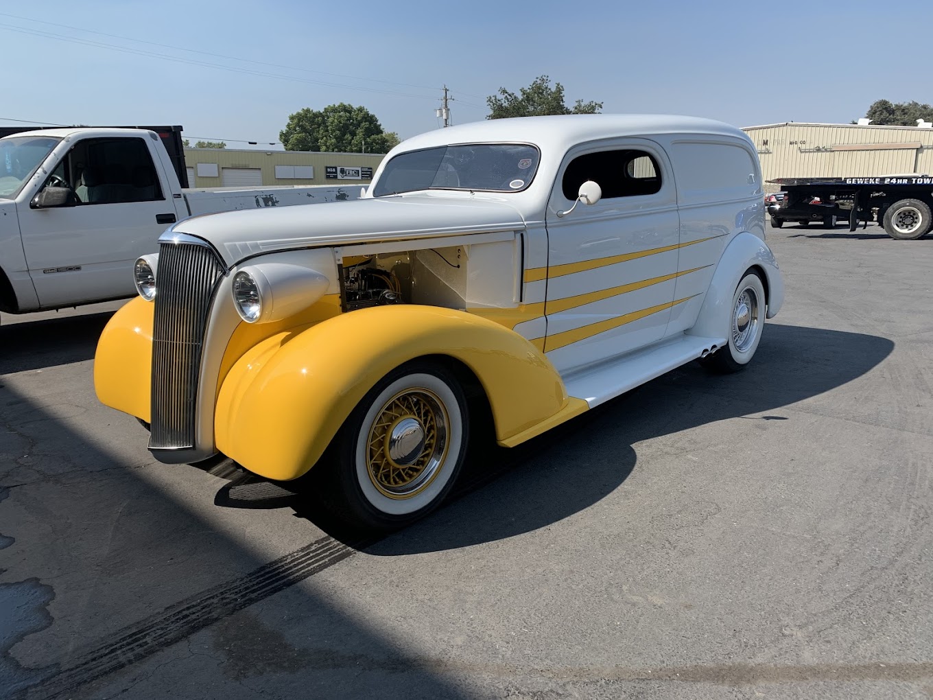 Classic 1930s style hot rod with yellow accents and custom design.