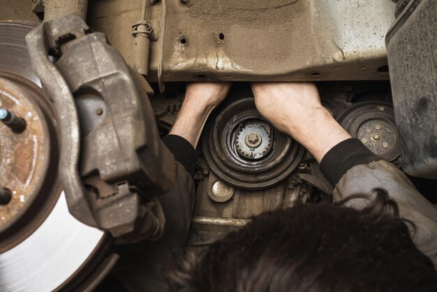 auto mechanic repairing car generator