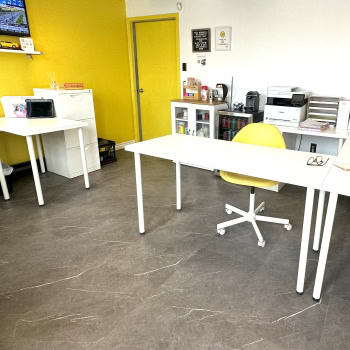 Modern transmission repair office with bright yellow accents and organized workspaces.