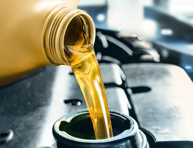 Transmission fluid being poured during preventive maintenance service.