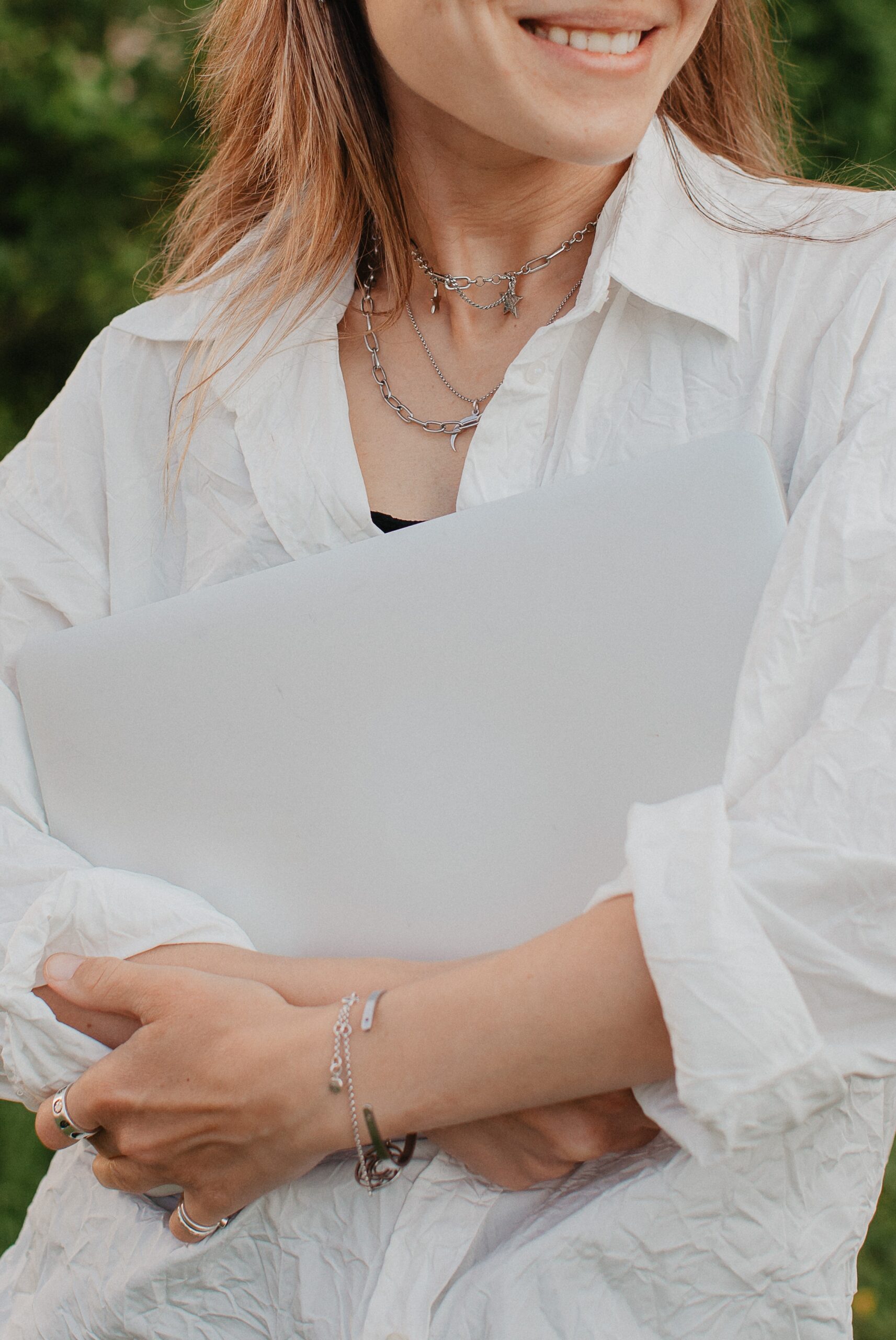 A young woman holds a laptop and smiles 2024 10 17 05 31 10 utc