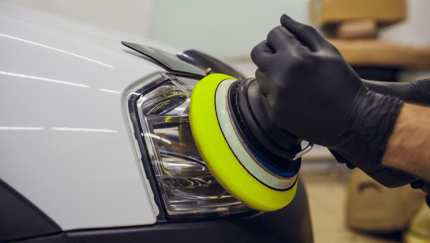 Auto detailing and polishing being performed on a vehicle headlight.