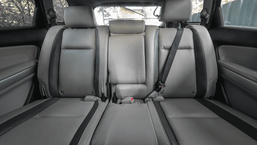 Interior car seats with seat belts in a vehicle.
