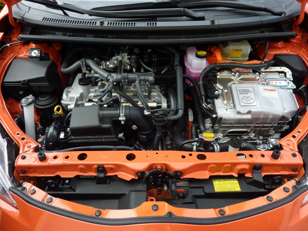 Engine compartment showcasing a new oil filter and clean engine oil during vehicle oil change.