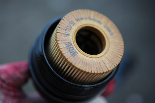 Car oil filter being replaced, close-up shot for vehicle oil change.