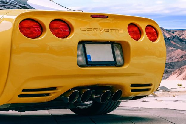 Yellow Corvette sports car with quad exhausts and taillights.