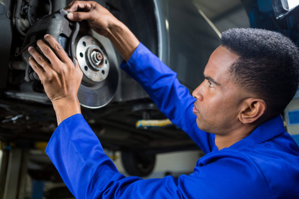 Mechanic conducting brake repairs