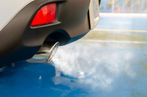 Exhaust pipe releasing smoke from a vehicle at Hillside Auto Clinic, specializing in auto repairs an.