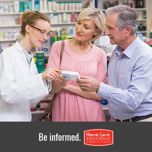 Pharmacist explaining prescription medications to senior patient