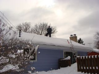 Home Inspector on Snowy Roof