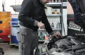 Auto repair technician inspecting car engine at Honest Engine Roseville.