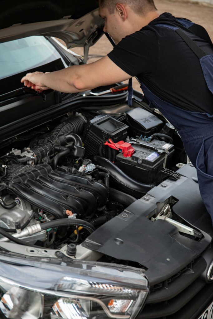 Skilled mechanic inspecting car engine at Honest Engine of Roseville for reliable auto repairs.
