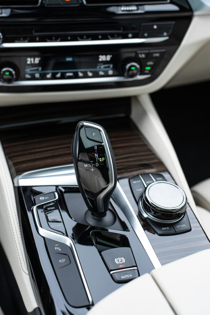 Luxury car gear shift and climate control system in a modern vehicle interior.