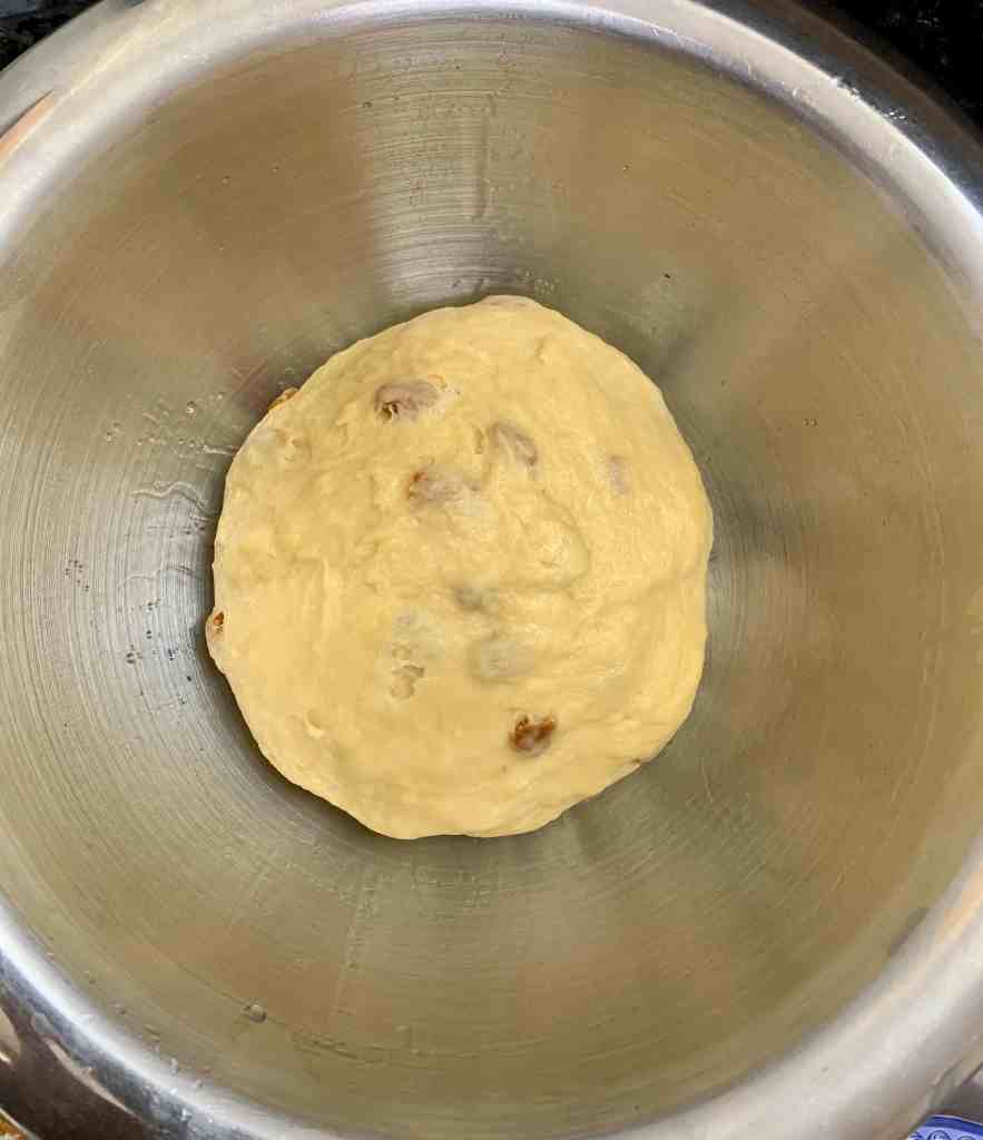 Soft banana bread dough in a stainless steel mixing bowl, ready for baking.