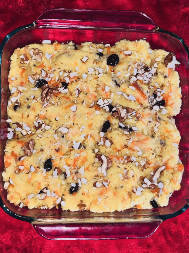 Creamy Hawaiian Macaroni Salad with vegetables and coconut topping in a glass dish.