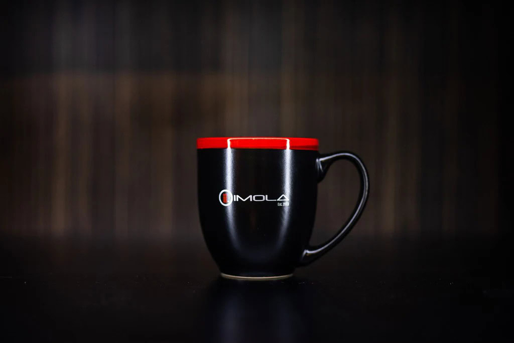 Imola Motorsports two-tone halo bistro mug with red and black design.
