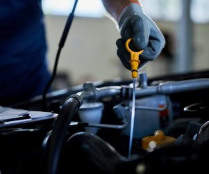 Technician performing precision upgrades on a high-performance vehicle engine.