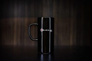 Black ceramic mug with Imola Motorsports logo for racing fans.