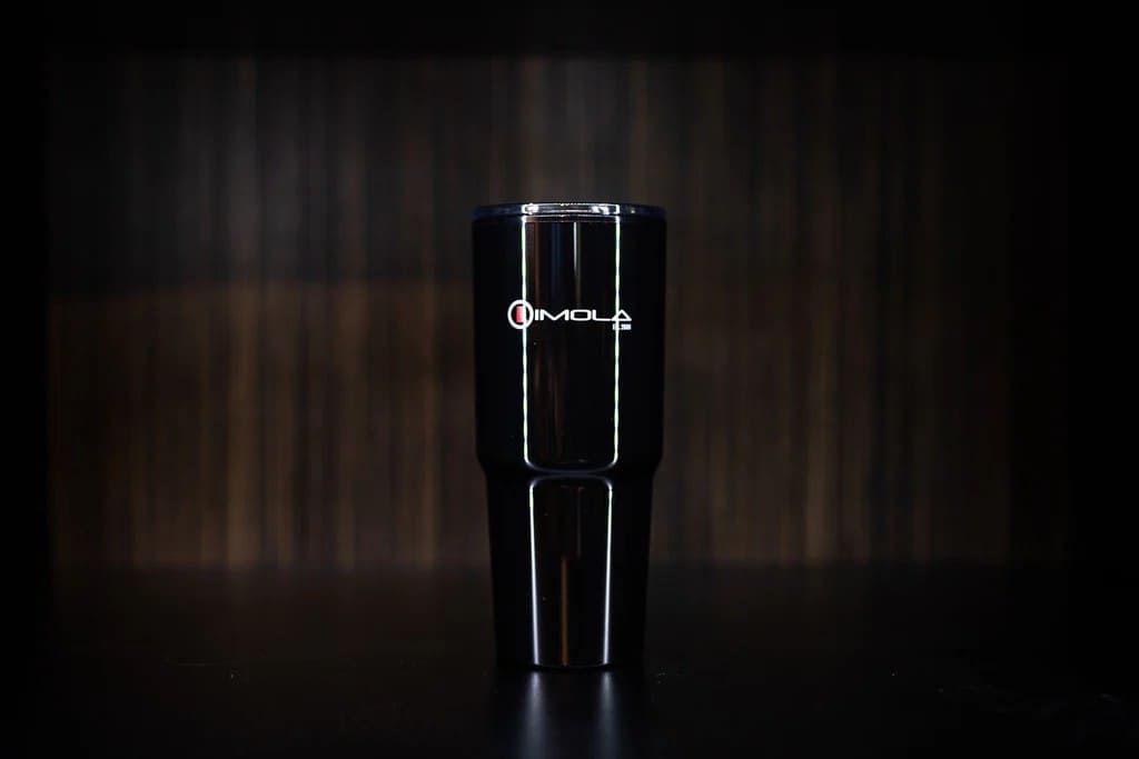 Imola Motorsports 32 oz. double wall travel mug on dark background.