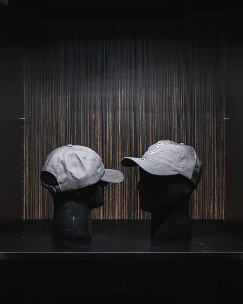 Gray baseball cap displayed on mannequin head.
