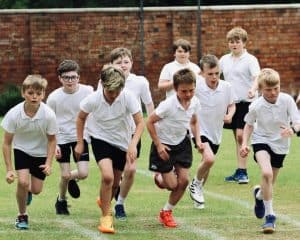 Young boys running during sports day at Inchmarlo School, outdoor activity.