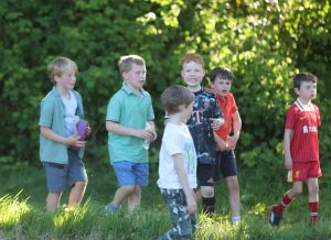 Children walking outdoors in lush green park at Inchmarlo.