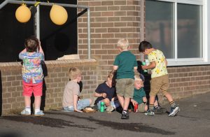 Children playing and exploring outside Inchmarlo community facility for kids.